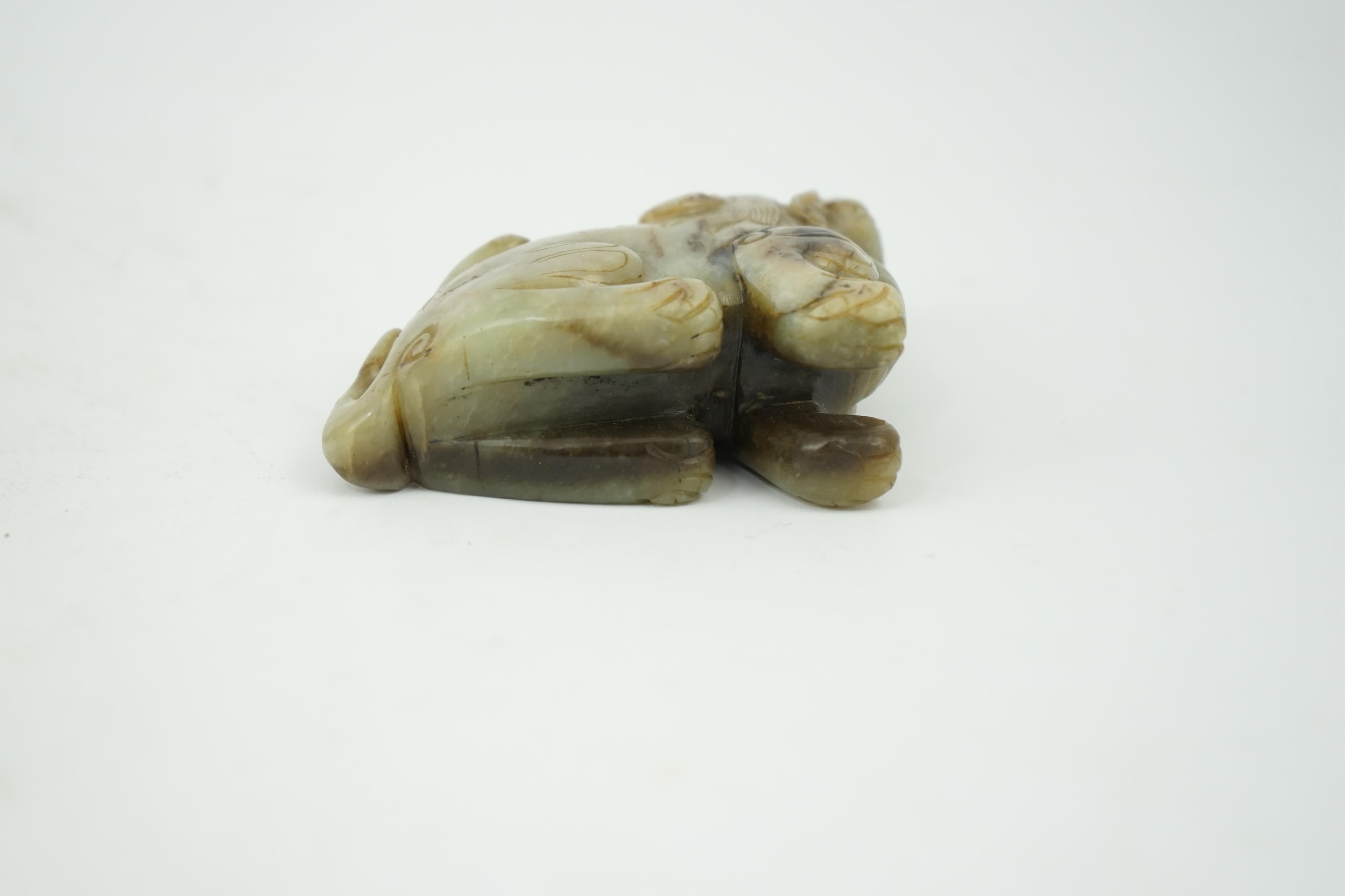 A Chinese pale grey green and black jade figure of a seated Mythical beast, Qing dynasty